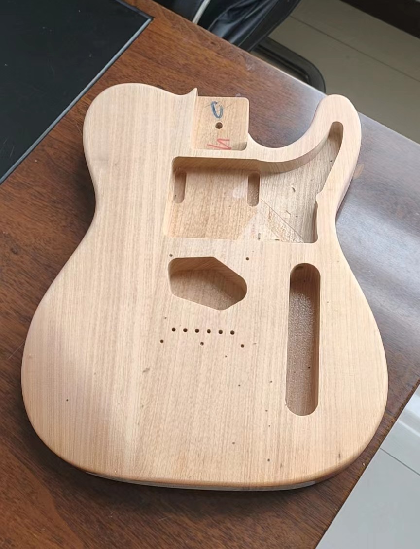 Pickup routing underneath pickguard